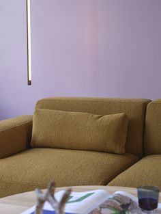 a brown couch sitting next to a wooden table