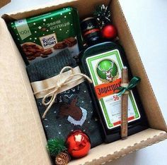 an open box filled with personal care products and christmas decorations, including soap, hand sanitizer, cinnamon sticks, pine cones, and other items