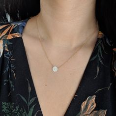 If you're looking for something classic and sophisticated, look no further with the Diamond Pave Circle Disk Necklace in 14k Gold! The circle shape is so modern and perfect for everyday wear. It can layer well with other necklaces, or stand on its own. It is set with mini diamonds for the perfect amount of sparkle!Adjustable chain from 16 to 18 inches. Diamonds (0.19 ct) 14k yellow gold Dimensions: 8.5mm Please allow up to 6 weeks for production.KAMARIA supports survivors of power-inequality vio Elegant 14k Gold Coin Necklace With Clavicle Chain, Elegant Jewelry With Delicate Chain And Round Disc, 14k Gold Round Coin Necklace Fine Jewelry, Modern Diamond Necklace With Delicate Chain, Elegant Round Coin Necklace With Clavicle Chain, Elegant Round Coin Necklace With Delicate Chain, Elegant Round Coin Necklace With Chain, Minimalist 14k Gold Round Disc Necklace, Minimalist Yellow Gold Circle Coin Necklace