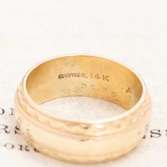 Rare and unique wide band from Cartier, with a cigar band vibe, and engraving on the outer edges. She's a perfect pinky ring too! 14kt yellow gold Size 5 and not resizable 7mm wide Engraved "F.F.A to C.A.C. 5-5-62" Please see qualitative report for more information. Yellow Gold Wide Band Ring Stamped 14k, Heirloom Yellow Gold Wide Band Ring, Heirloom Ring With Thick Decorative Band, Heirloom 14k Gold Wide Band Ring, Heirloom Wide Band Yellow Gold Ring, Heirloom 14k Gold Open Band, Heirloom Engraved Ring With Decorative Wide Band, Heirloom 14k Gold Wedding Band Thick Shape, Heirloom Rings With Decorative Wide Band