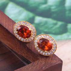 This Sterling Silver Jewelry set features an Elegant Art With Natural Hessonite Gemstone. The cavity is made from genuine solid 925/92.5 Sterling silver with 18k Gold Plating and stamped as S925. This Jewelry is Lead free and Rhodium plated to prevent scratches and tarnish. ITEM DESCRIPTION Item Code: JACBS2/45 Metal: 18k Gold over 925/92.5 Sterling Silver Gemstone: Genuine Natural Hessonite Gemstone Shape: Oval Gemstone Size: 6 X 8 MM Ring Dimension:- Length: 12 MM Width: 11 MM Weight: 3.93 gm Classic Orange Jewelry For Gift, Classic Orange Jewelry As Gift, Luxury Citrine Earrings, Round Gold Gemstones Fine Jewelry, Gold Ruby Gemstones For Anniversary, Orange Diamond Jewelry As A Gift, Exquisite Yellow Gold Round Gemstones, Elegant Citrine Jewelry With Gemstone Accents, Luxury Citrine Jewelry With Matching Earrings