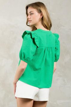 Introducing the Puff Sleeve Textured V-Neck Top in a vibrant green hue. This lightweight blouse features a split neckline and ruffle detail at the shoulder for a touch of playfulness. Its boxy fit makes it easy to tuck into your favorite trousers or pair with flare jeans. Green Puff Sleeve Blouse For Spring, Trendy Green Cotton Puff Sleeve Top, Chic Green Puff Sleeve Top, Green V-neck Top For Day Out, Summer Green Cotton Puff Sleeve Top, Green Cotton Puff Sleeve Top For Summer, Green Puff Sleeve Blouse For Summer, Green V-neck Top With Ruffles, Green Puff Sleeve Summer Top