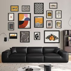 a living room filled with black leather furniture and pictures on the wall above it's coffee table