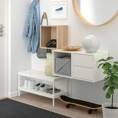 a room with a skateboard, coat rack and mirror