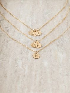 Personalize this 14k gold filled dainty initial disc necklace with a letter, number or symbol. Choose up to 5 tiny gold-filled discs. Each mini disc is hand stamped and you can choose your finish and font style. Charms will overlap each other.  DETAILS  * Tiny gold filled discs measure just 10mm * Gold filled chain, gold filled spring clasp and jump rings * Gold filled is a high-quality long-lasting material, it will not rub off like gold-plating  HOW TO ORDER  * Select your number of Charms/Length and Finish from the drop-down menus on the side and add to cart * Make sure to keep in mind the font you'd like from the photos * Leave your initials/symbols and font choice in the blank text box under the photo at checkout ** REMEMBER: CHOOSE YOUR FONT! **  GOLD FILLED  Gold filled has 100x the Letter Necklace Gold, Initial Disc Necklace, Dainty Initial Necklace, Gold Letter Necklace, Gold Letter, Initial Necklace Gold, Disc Necklace, Letter Charms, Gold Letters