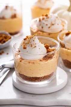 small desserts with whipped cream and graham crackers in glass dishes on a white tray