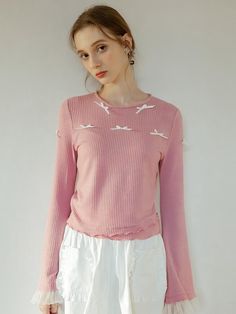 This is a t-shirt with a ribbon attached to the top of the garment. Rather than simple printing, ribbons are added to the clothes, creating a more three-dimensional and feminine mood. White see-through fabric was added to the ends of the sleeves. - Neat silhouette with round neck- Design that looks like fabric has been added to the hem- The design of the sleeves gets wider toward the end, giving the effect of making the arms look thinner. Feminine Tops With Ribbon For Spring, Feminine Ribbon Tops For Spring, Chic Spring Tops With Ribbon, Pink Tops With Ribbon For Spring, Pink Ribbon Tops For Spring, Bell Sleeves Top, Sleeves Top, The Clothes, Neck Designs