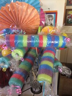 there are many colorful items on the counter top in this room, including umbrellas and candy