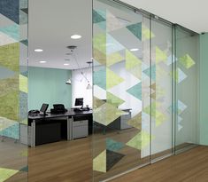 an office with glass walls and a plant in the corner