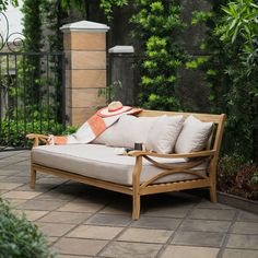 a wooden couch sitting on top of a patio