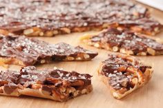 several pieces of chocolate and nuts arranged on a cutting board