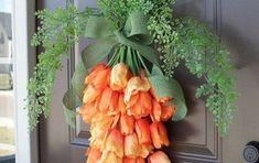 a bunch of orange flowers hanging from a door