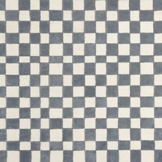 a gray and white checkered rug on the floor