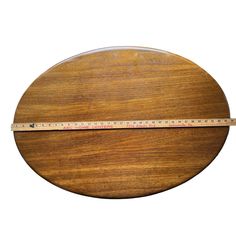 a wooden object with a measuring tape on the top and bottom part of it's surface