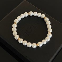 In a world saturated with mediocrity, nothing can rival the authenticity of traditional luxury. This subtly opulent bracelet showcases genuine white freshwater pearls, elegantly interspersed with lab diamond studded rondelles in gold. Hand-strung with care in our Orlando studio, this stretch bracelet adjusts over the wrist for easy transitions and offers versatile styling options with a comfortable wear. Our Men's Pearls Collection, features sophisticated fresh water pearl necklaces and bracelet Elegant Pearl Jewelry With Gold Beads, Luxury White Beaded Pearl Bracelet, Classic Gold Pearl Beaded Bracelets, White Pearl Embellished Bracelets For Party, Formal White Pearl Bracelets, White Pearl-embellished Bracelet For Party, Formal White Pearl Embellished Bracelets, Elegant Pearl White Jewelry With Gold Beads, White Pearl Embellished Bracelet