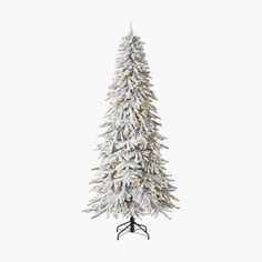 a white christmas tree with snow on it's branches and the base is standing upright