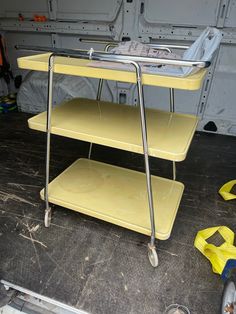 a yellow cart sitting in the back of a van