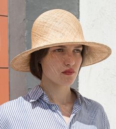 "Pine" is a feathery summer sun hat with a wide flared brim. The shapely curve of the brim ensures a perfect fit and underlines a clear, feminine look. The material "Bao" made of the undyed fibres of the baobab tree is pleasantly permeable to air and ensures maximum wearing comfort. A hoop integrated into the edge of the hat provides additional stability. Available in sizes 55 cm - 60 cm. Colour "nature" Hat of "Bao" - Monkey bread tree  Grosgrain ribbon (inside) made of 66% cotton and 34% polya Elegant Sun Hat With Curved Brim In Toquilla Straw, Elegant Toquilla Straw Sun Hat With Curved Brim, Elegant Toquilla Straw Fedora For Spring, Elegant Natural Fedora Hats, Chic Lightweight Natural Straw Hat, Chic Toquilla Straw Hat, Elegant Natural Fedora Sun Hat, Elegant Natural Brimmed Panama Hat, Handmade Brimmed Boater Hat In Toquilla Straw