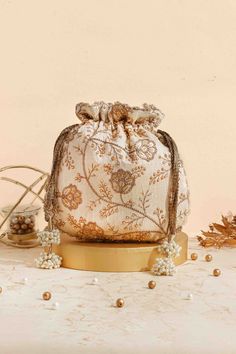 Colour: Cream Embroidered front and back. Dimensions (LxB): 9.5" x 9" (24 cm x 23 cm) Handle drop: 5" (13 cm) Material : Embroidered poly silk, poly satin lining, woven golden thread drawstrings and handle, scallop lace and pearl tassels. Traditional Potli Bag With Dori Work For Reception, Zari Work Potli Bag For Festivals And Reception, Festival Reception Potli Bag With Zari Work, Bollywood Style Potli Bag With Dori Work For Reception, Gold Potli Bag With Dori Work For Reception, Festive Gold Embroidery Potli Bag, Festive Potli Bag With Gold Embroidery, Festive Gold Potli Bag For Reception, Bollywood Style Gold Bag For Reception