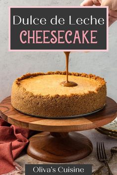 a cheesecake on a cake plate with a sign that says dulce de leche cheesecake