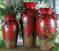 a group of red vases sitting next to each other