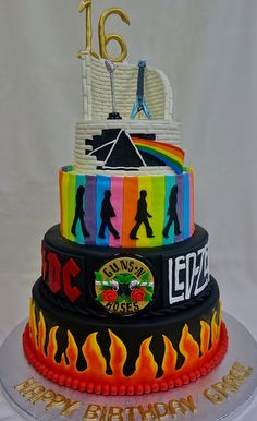 a multi layer cake decorated with the colors of people and symbols