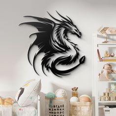 a black metal dragon wall art on a white wall in a child's room