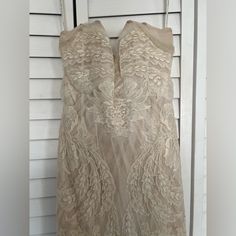 the back of a dress hanging on a door