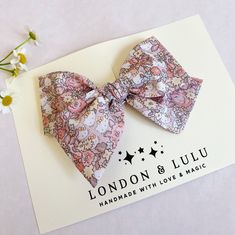 "Liberty of London x HK fabric imported from Japan featuring dusty pink floral print.  Comes in our twirl style bow on a lead free alligator hair clip clip, a soft nylon baby headband or our hard bow headband. Hard knot headband fits toddlers, kids and adults.  Small size bow measures 3.75\" Medium size bow measures 4.50\" Large size bow measures 5.50\" Top knot measures 3.0\" Hard covered headband has a large sized bow.  Handmade with love and magic in Southern California." Whimsical Pink Hair Accessories With Handmade Flowers, Cute Pink Hair Accessories For Spring, Pink Hair Bow Accessories For Spring, Pink Hair Accessories With Handmade Flowers For Summer, Spring Pink Hair Accessories With Bow, Pink Flower Hair Accessories For Summer, Cute Satin Bow For Spring, Pink Adjustable Hair Accessories For Summer, Playful Bow Hair Accessories For Summer