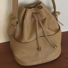 Authentic Coach Leather Bag In Great Used Condition No Rips Or Surface Damage Scratches To The Leather, Some Discoloration On The Bottom (See Pics) Adjustable Strap So It Can Be Worn Longer Or Shorter Crossbody Or Shoulder Bag Classic Drawstring Bucket Style With 2 Front Pockets Inner Zipper Pocket Approx. Dims: 10.5" Wide At Middle, 11" At Top (Extended), 8.75" Wide On Bottom Base 11.25" High 5.25" Deep 17.5 - 19.5" Adjustable Drop (Shoulder To Bag Top) Coach Leather Bucket Bag With Removable Pouch, Classic Coach Bucket Bag For Everyday Use, Coach Leather Bucket Bag For Daily Use, Classic Coach Bucket Bag For Daily Use, Coach Leather Bucket Hobo Bag, Coach Everyday Bucket Satchel, Coach Leather Satchel Bucket Bag, Coach Leather Travel Bucket Bag, Coach Beige Bucket Bag