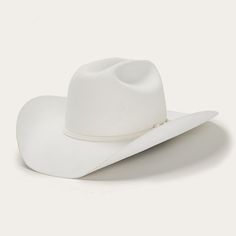 A premium wool cowboy hat featuring a classic cattleman's silhouette with a taller 4 5/8" crown and a curved 4" brim. Adorned with refined accents like a 3-piece silver buckle on the matching hatband, this high-quality hat offers both style and elegance. The leather interior sweatband ensures comfort and keeps you cool. Elevate your Western look with this exceptional cowboy hat. Head circumference size: Adjustable (22.83-23.62 in) (58-60 cm) Brim: 4" Crown: 4 5/8" Material: 4X Fur Felt Accents: White Cowboy Hat, Tuxedo Accessories, Felt Cowboy Hats, Chapeau Cowboy, Thigh Boot, Western Hats, Quality Hats, Cowgirl Hats, Hat Band