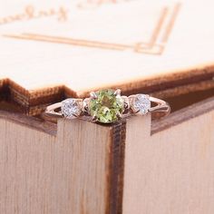 "Simple & dainty 14k rose gold peridot promise ring for her, Elegant 3 stone womens promise ring, Gold 3 stone peridot engagement ring WE OFFER UNLIMITED PERIOD INSTALLMENTS PLAN This is a beautiful, stunning, feminine ring that works well for all occasions, styles, and ages. You will love it! Ring information Main stone: Peridot Approximate size: 4.5mm Accent stone: Cubic zirconia Approximate size: 3mm Metal type: Gold Metal stamp: 14k solid gold Customization / Replacements It's easy to cr Green Dainty Jewelry For Promise, Dainty Peridot Promise Ring, Rose Gold Three Stone Jewelry For Anniversary, Green Peridot Promise Jewelry, Green Peridot Jewelry For Promise, Round Peridot Promise Jewelry, Peridot Center Stone Jewelry For May Birthstone, Three Stone Peridot Ring Jewelry, Three Stone Peridot Ring