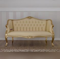 an antique style couch is sitting on the floor