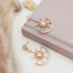 "This gold statement earrings feature double star burst design with a smaller starburst posts attached to a sparkly larger sunburst charm nestled in a crescent moon.  A unique large celestial earrings perfect for going out or whenever you want an extra pop of sparkle. DIMENSION: ----------------- Earrings : 1 inch wide x 1.5 inch long For other celestial jewelry, click here : https://www.etsy.com/shop/YsmDesigns?ref=seller-platform-mcnav&search_query=celestial PACKAGING/ GIFTING: --------------- Celestial Packaging, Celestial Earrings, Earrings Double, Starburst Earrings, Star Burst, Moon And Star Earrings, Satin Ribbon Bow, Night Court, San Ramon