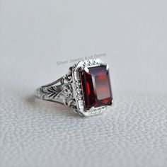 Gemstone-Garnet Shape-Rectangle Stone Size- 10x12 MM Metal-925 Sterling Silver This One of a kind ring is adorned with beautiful Garnet Gemstone set in sterling silver. About gemstones-Garnet is intense red color stone resembling the glistening, deep red seeds of the fruit. This red stone is associated with true friendship, devotion,loyalty, self esteem, success and passion. Garnet protects from negativity and warn off evil spirits and leads way to spiritual world. Wearing Garnet stone promotes Classic Square Sterling Silver Rings, Rectangular Gemstone Signet Ring In Fine Jewelry Style, Elegant Sterling Silver Signet Ring With Rectangular Stone, Square Gemstone Jewelry For Anniversary, Classic Rings With Rectangular Stone For Gift, Classic Ring With Rectangular Stone For Gift, Formal Ruby Ring With Rectangular Stone, Classic Ruby Ring With Rectangular Stone For Anniversary, Classic Rectangular Ruby Promise Ring