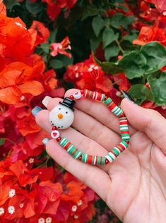 Adorable snowman holiday styled bracelet ❤️ This Christmas themed bracelet is made with red, green, and white 6mm heishi beads, acrylic red heart beads, red seed beads & a ceramic snowman charm  What a better way to spread some cheer? This bracelet is a wonderful accessory for the holidays! ✨ stack it with other jewelry or wear it alone! Gift it to someone special or rock it yourself 💞 (You will receive one snowman bracelet. Not identical to bracelet shown in pic but very similar!) Snowman Accessories, Ceramic Snowman, Heishi Bracelet, Bracelet Christmas, Christmas Bracelet, Christmas Accessories, Crystal Beads Bracelet, Heishi Beads, Holiday Jewelry