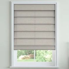 a window with blinds that are closed in front of a white wall and windowsill