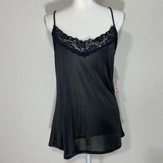 Free Kisses Black Camisole Tank Blouse Size: Large Color: Black Approximate Measurements Pit To Pit: 20in Length: 24in New With Tag Flirty Camisole With Built-in Bra For Night Out, Flirty Sleeveless Sheer Top, Black Flirty Tank Top For Summer, Flirty Black Tank Top For Summer, Flirty Black Summer Tank Top, Black Tank Top With Built-in Bra For Loungewear, Casual Black Camisole For Loungewear, Black Cami Top With Built-in Bra, Sheer Stretch Camisole Top