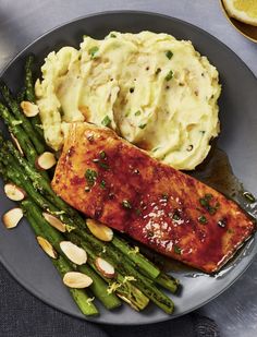 salmon and asparagus on a plate with mashed potatoes, almonds and green beans