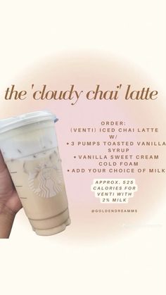 a hand holding up a cup with the words, the cloudy chai latte