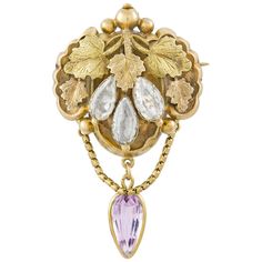 A late Georgian gold and gemset brooch, the brooch comprising ornately-carved foliate motifs in yellow and rose gold, set with three pear-shaped blue topaz and suspending a pear-shaped pink topaz drop, all set in yellow gold to a closed back and brooch fitting, circa 1830, measuring approximately 4.7 x 2.7cm, gross weight 5.5 grams. Unmarked tested as 15ct gold and 9ct gold pin and catch. A Georgian brooch in very good condition. This lovely and naturalistic brooch comes from the collection of Bentley & Skinner, the London jewellers by appointment to both Her Majesty the Queen and His Royal Highness the Prince of Wales. Created in around 1830, this sweet brooch features detailed gold vine leaf with delightful and subtly coloured topaz. This late Georgian piece would be stunning pinned to t Historic Jewelry, Regency Jewelry, Georgian Jewelry, Nouveau Jewelry, Antique Brooches, Unusual Jewelry, Gold Necklace Set, Pink Topaz, Jewellery Shop