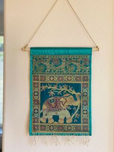 an elephant tapestry hanging on the wall