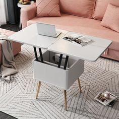 a living room with a couch, coffee table and laptop on top of the table