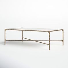 a table that is made out of wood and glass with a metal frame on the top