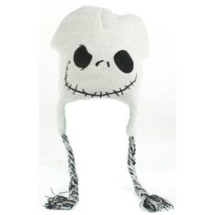 a white knitted hat with black eyes and a jack skellingy face on it