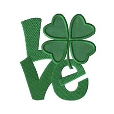 the word love with four leaf clovers in green and white embroidery on a white background