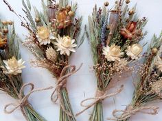 four dried flowers tied together with twine