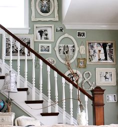 the stairs are decorated with pictures and frames