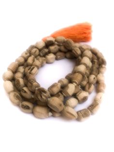 Tulsi (Tulasi) japa mala made from hand carved beads, hand knotted on white cotton thread, in Vrindavan, India. The beads are approximately 6mm to 9mm, with Large orange-colored cotton tassel. Total length is approximately 40 - 48 inches. Vrindavan grown, Vrindavan crafted.™ Use japa mala necklace as is, either as a necklace, prayer beads or a bracelet wrapped approximately six times around your wrist or use the beads for other crafting projects. The name "Tulasi" means "she who is incomparable. Traditional Natural Beads As A Gift, Traditional Natural Beads For Gifts, Traditional White Mala For Puja, Adjustable Artisan Mala For Rituals, Holistic Wooden Beads Mala For Rituals, Bohemian Mala With Large Beads For Meditation, Bohemian Mala With Wooden Beads For Festivals, Traditional Handmade Mala For Meditation, White Mala With 8mm Beads For Rituals