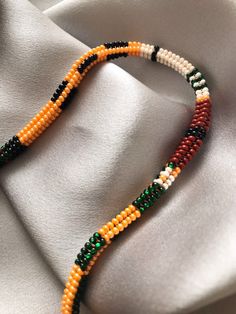 This beautiful handmade beaded Rope necklace is the perfect addition to your jewelry collection. It features a unique combination of high-quality beads, expertly woven together to create a stunning accessory that is both stylish and comfortable to wear. .: Necklace size Available in three versatile sizes to choose: 40 cm, 46 cm and 52 cm. .:Care Instructions To keep your beaded bracelet looking its best, avoid direct contact with water, perfumes, and cosmetics. .: Additional Information If you h Orange Oval Beaded Necklaces As Gifts, Orange Oval Beaded Necklace For Gifting, Orange Oval Beaded Necklace For Gift, Orange Beaded Bracelets For Jewelry Making, Orange Spacer Beads For Gifts, Orange Beaded Necklaces With Spacer Beads As Gift, Artisan Beaded Chain Bracelets With Round Beads, Multi-strand Beaded Bracelets With Large Beads As Gift, Orange Beaded Necklaces With Oval Spacer Beads